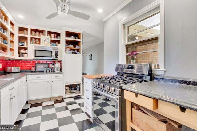 kitchen with crown molding, ceiling fan, appliances with stainless steel finishes, tile patterned floors, and open shelves