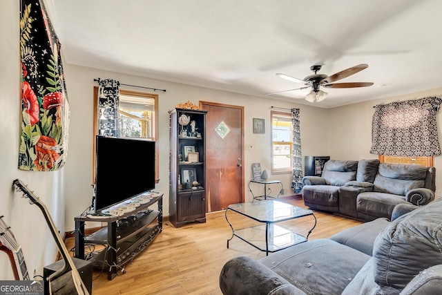 living room featuring light wood-type flooring and ceiling fan