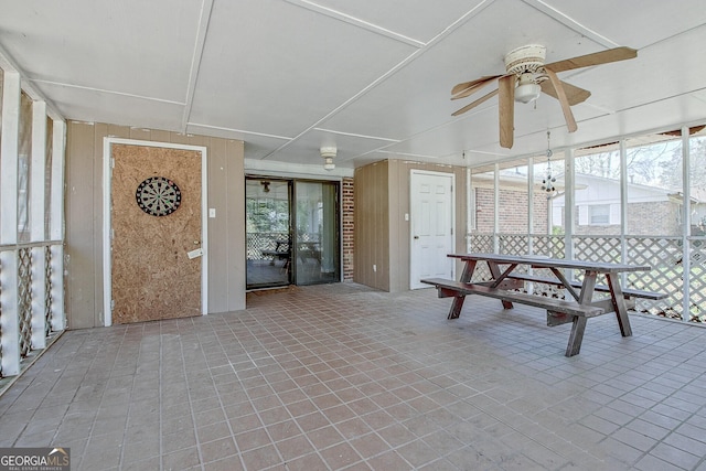 unfurnished sunroom with a ceiling fan