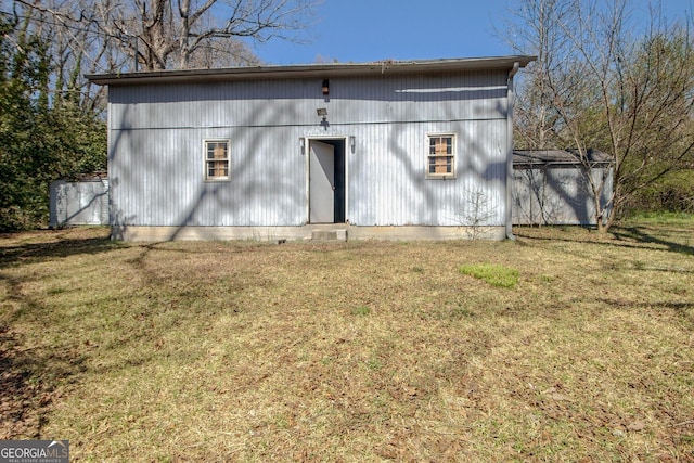 exterior space featuring a lawn and an outdoor structure