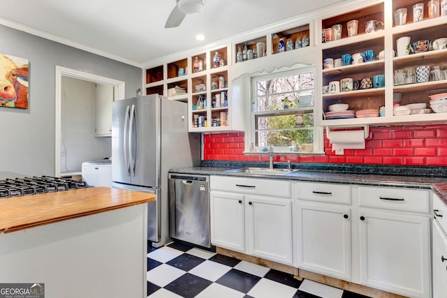 kitchen with open shelves, light floors, appliances with stainless steel finishes, and a sink