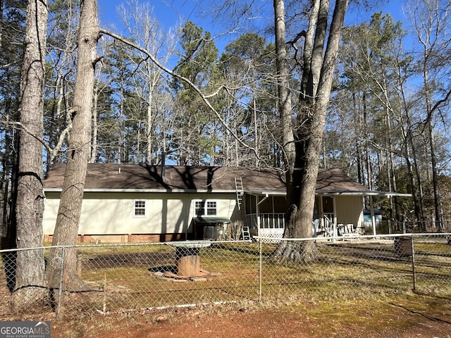 view of front of home featuring fence private yard and a shingled roof