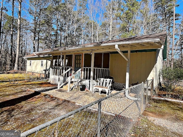 view of front of property featuring fence