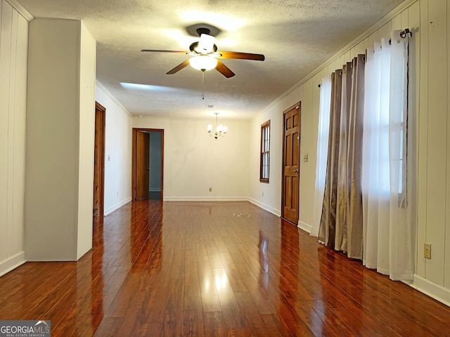 unfurnished room featuring a textured ceiling, hardwood / wood-style floors, crown molding, and ceiling fan with notable chandelier