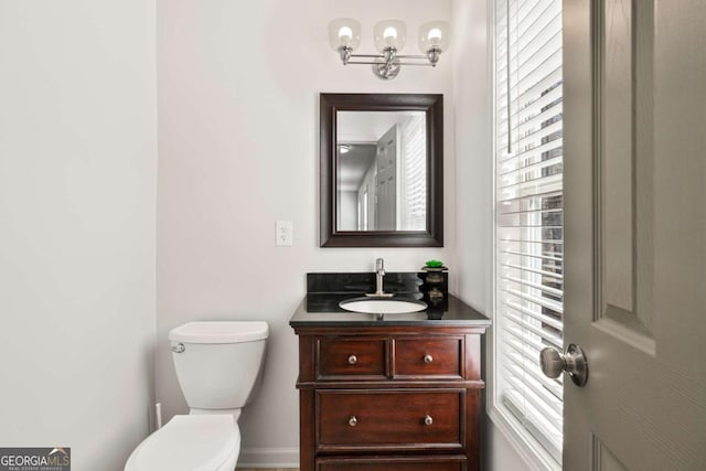 bathroom featuring toilet and vanity