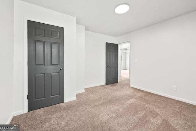 unfurnished bedroom with carpet flooring and baseboards