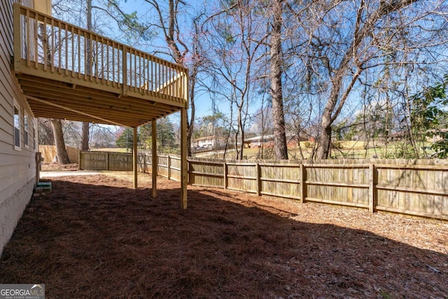 view of yard with a deck and a fenced backyard