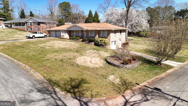 ranch-style house featuring driveway, a front yard, and an attached garage