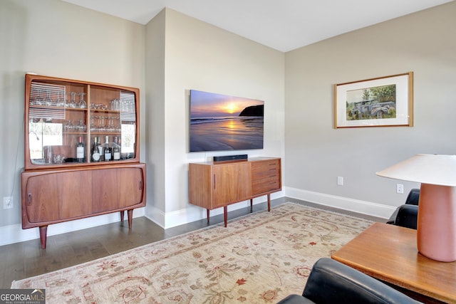 living room featuring baseboards and wood finished floors