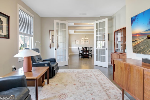 office area featuring a chandelier, visible vents, french doors, and wood finished floors