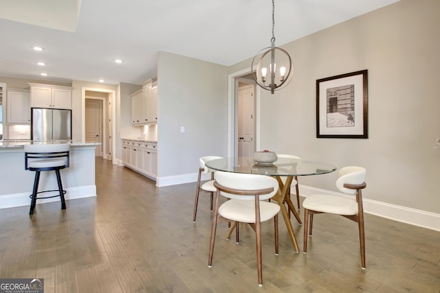 dining space featuring recessed lighting, baseboards, dark wood-type flooring, and a chandelier