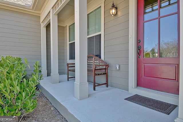 view of exterior entry with a porch