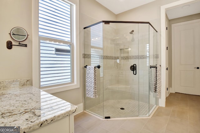 full bathroom featuring tile patterned floors and a shower stall