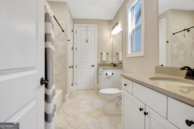 full bath with toilet, two vanities, and a sink