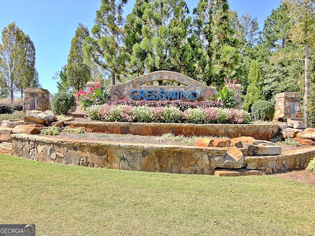 community / neighborhood sign with a yard