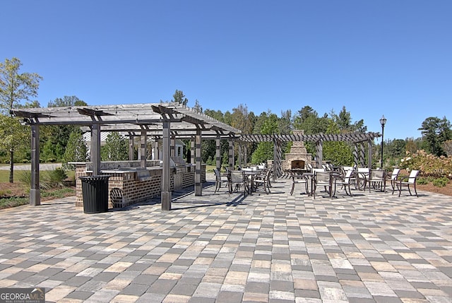 view of home's community featuring outdoor dry bar, a pergola, and a patio