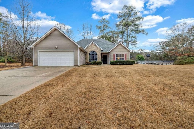 single story home featuring a garage, concrete driveway, and a front yard