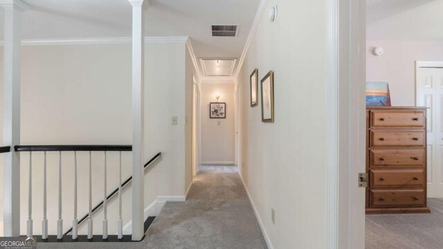 corridor with an upstairs landing, visible vents, carpet, baseboards, and attic access