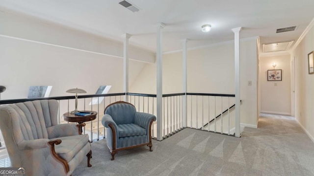 living area with an upstairs landing, visible vents, carpet, and ornamental molding