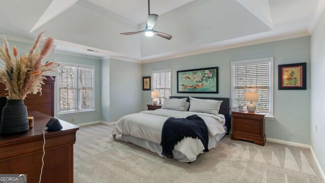 bedroom with baseboards, a raised ceiling, crown molding, and light colored carpet