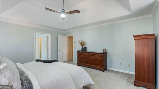 bedroom with a raised ceiling, ornamental molding, baseboards, and light carpet