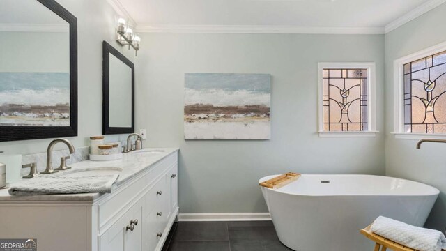 bathroom with a soaking tub, tile patterned flooring, baseboards, ornamental molding, and double vanity