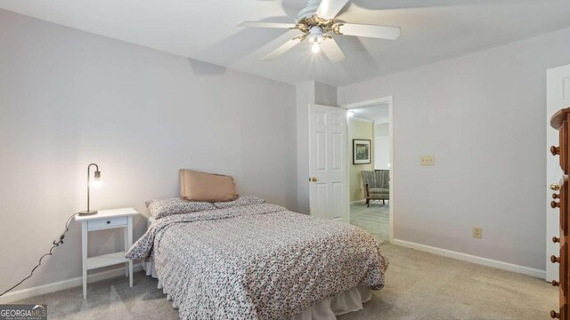 bedroom featuring baseboards, a ceiling fan, and light carpet