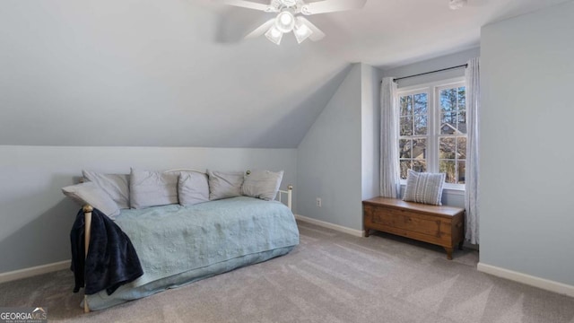 carpeted bedroom with ceiling fan, baseboards, and vaulted ceiling