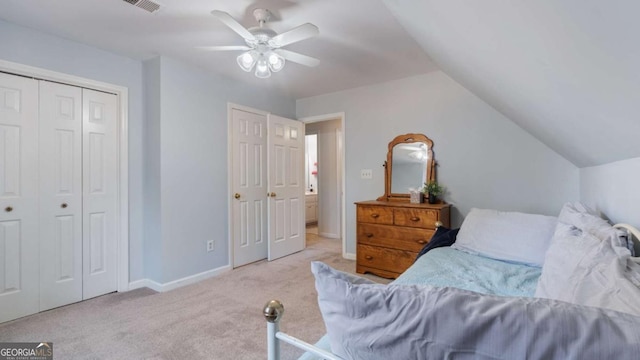 carpeted bedroom with visible vents, a closet, baseboards, ceiling fan, and vaulted ceiling