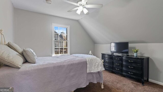 carpeted bedroom featuring baseboards, ceiling fan, and vaulted ceiling