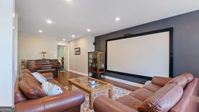 cinema room featuring recessed lighting, baseboards, and wood finished floors