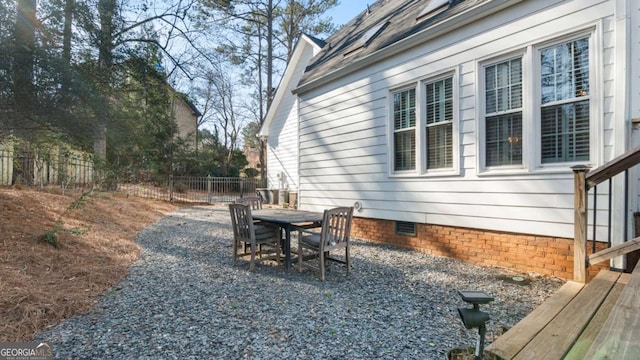 view of yard with outdoor dining area and fence