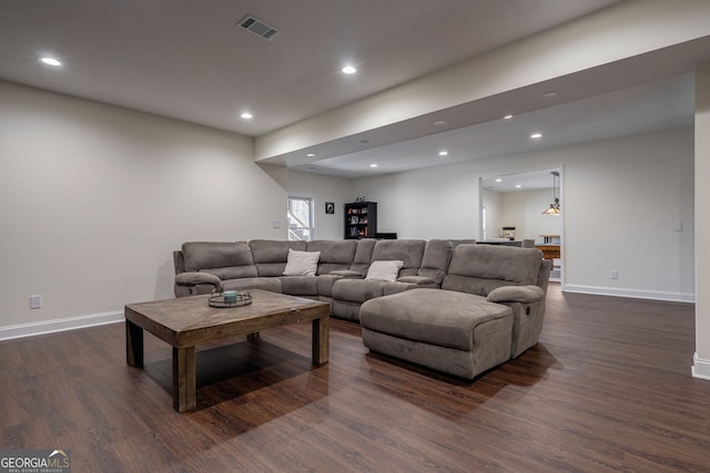 living area featuring recessed lighting, visible vents, dark wood-style flooring, and baseboards