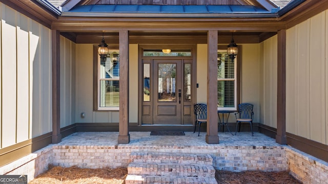 property entrance featuring a porch and board and batten siding