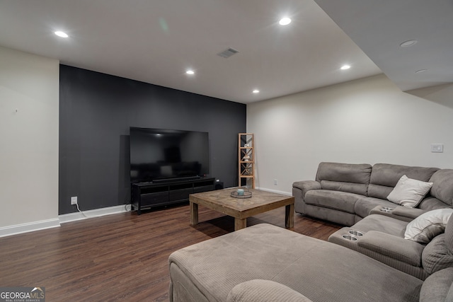 living room with recessed lighting, visible vents, and wood finished floors