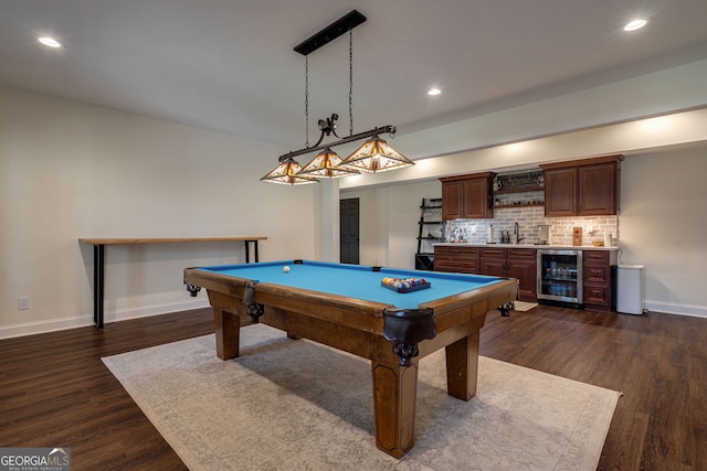 game room with dark wood-type flooring, a sink, wine cooler, wet bar, and baseboards