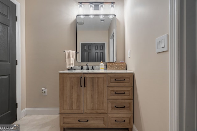 bathroom featuring vanity and baseboards