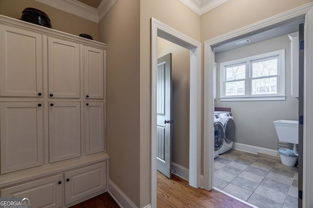 laundry area featuring visible vents, ornamental molding, separate washer and dryer, baseboards, and laundry area