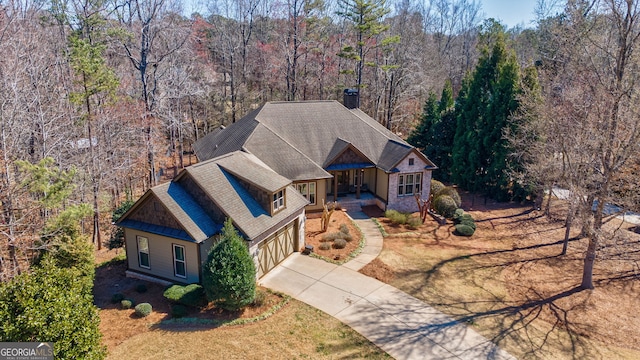 birds eye view of property with a view of trees