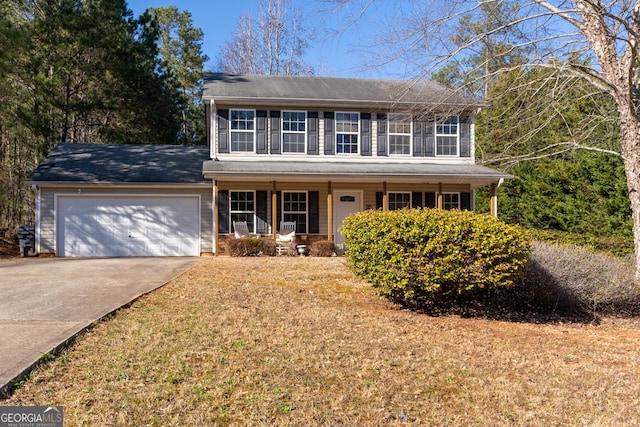 colonial home featuring concrete driveway, a porch, and a garage