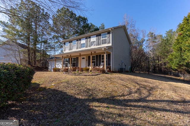 colonial-style house with covered porch, cooling unit, and an attached garage