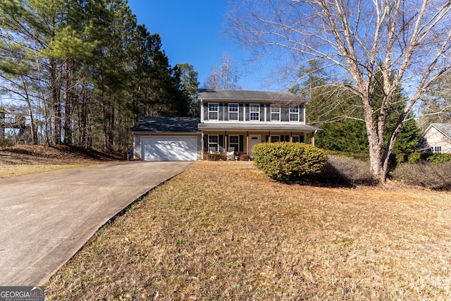 view of front of house with a porch, concrete driveway, and a garage