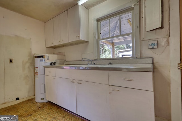 kitchen with water heater, light floors, light countertops, and a sink