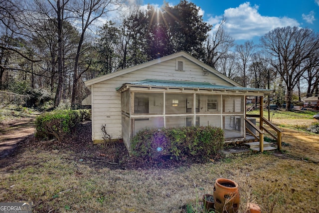 view of front facade featuring a sunroom and metal roof