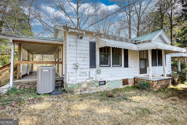 exterior space featuring crawl space and metal roof