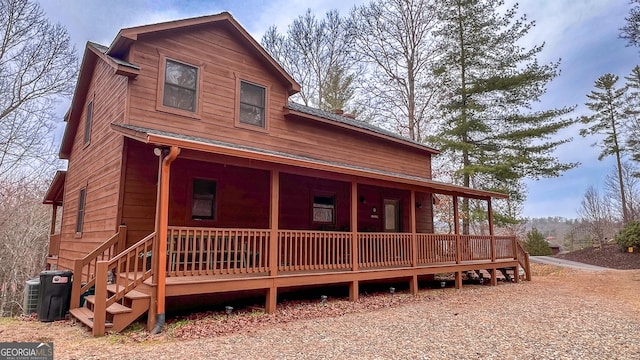 view of front of property with a porch and central AC unit