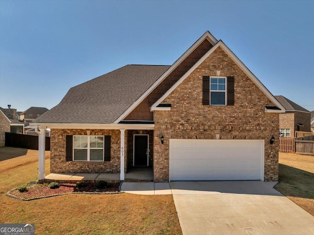 view of front of home featuring brick siding, a porch, concrete driveway, and fence