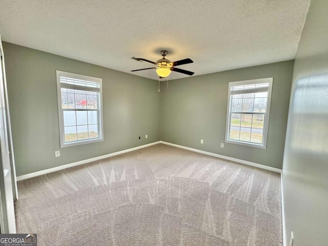 unfurnished room featuring a healthy amount of sunlight, baseboards, and carpet floors