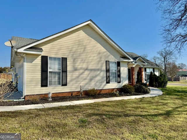 view of side of home featuring a yard