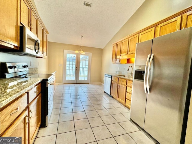 kitchen with light tile patterned floors, visible vents, a sink, stainless steel appliances, and french doors